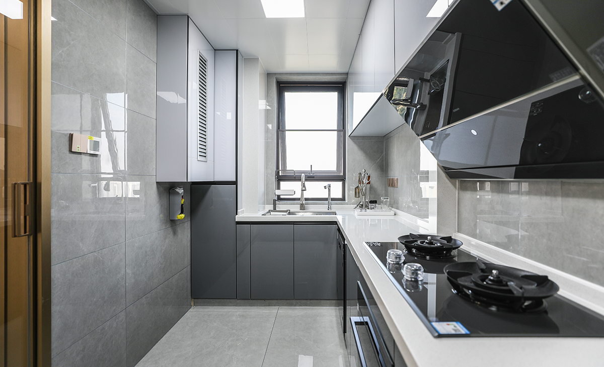 該套房子廚房空間很大，L型兩面櫥柜，另外冰箱邊上也有操作臺，顏色簡潔明快，材質要干凈和好打理，白色的吊頂和淺色的櫥柜相呼應，各種廚房電器全部配齊，滿足主人制作各種美食的需求。