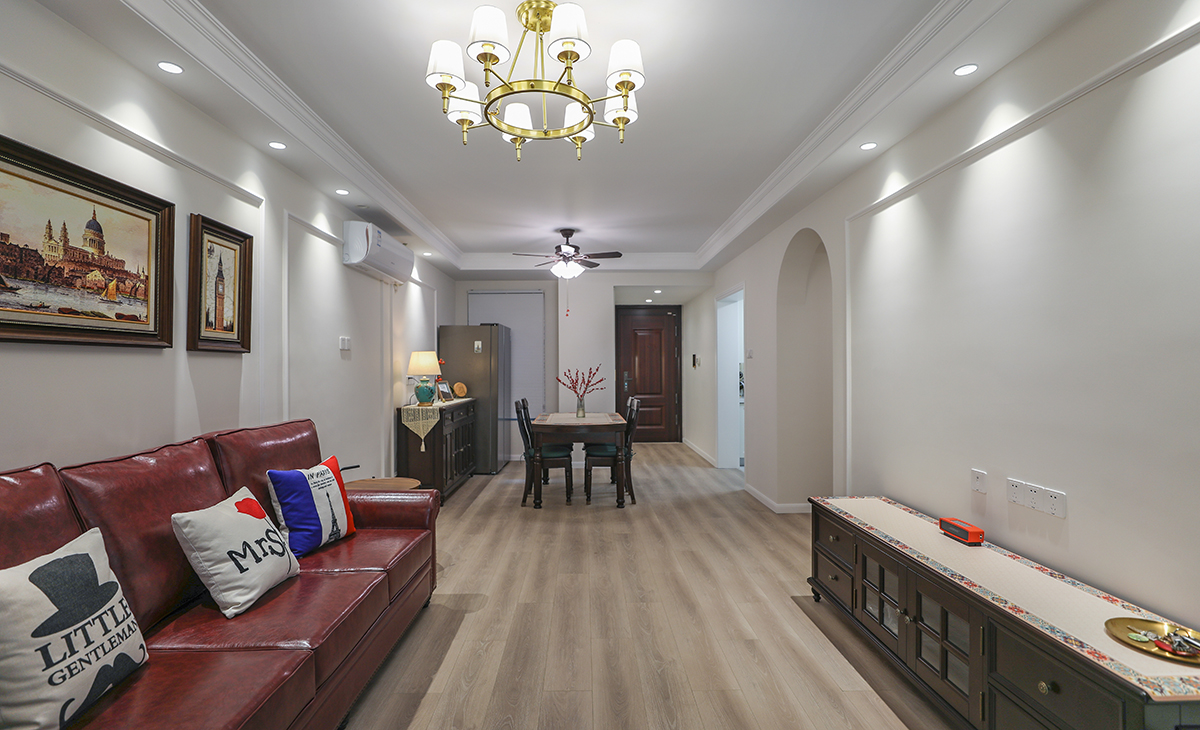 高飽和度的皮質沙發(fā)把復古的格調演繹出來，吊燈和落地燈的選擇都共同打造油畫一樣的美感氛圍。暖色調的墻漆和地面瓷磚相呼應，懸掛背景墻上的裝飾畫更是恰到好處，精心挑選的畫框和位置，提升整體設計效果。美式復古風的濃郁風情在這個客廳的種種細節(jié)里，體現的非常充分。