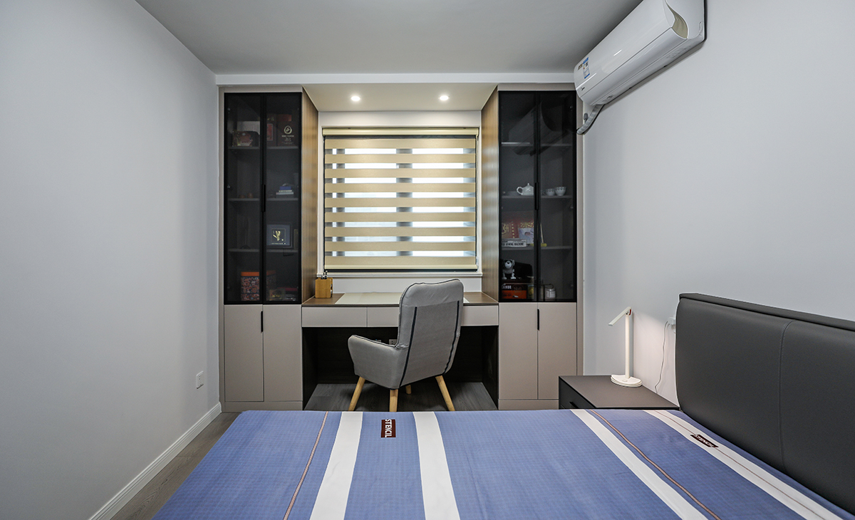 次臥寫字臺兩側，也做了玻璃柜，平時做書房用，供外孫住，設計上注重舒適和實用性，同時也考慮到了居住者的個性和審美需求。整個設計給人一種清新、自然、舒適的感覺。