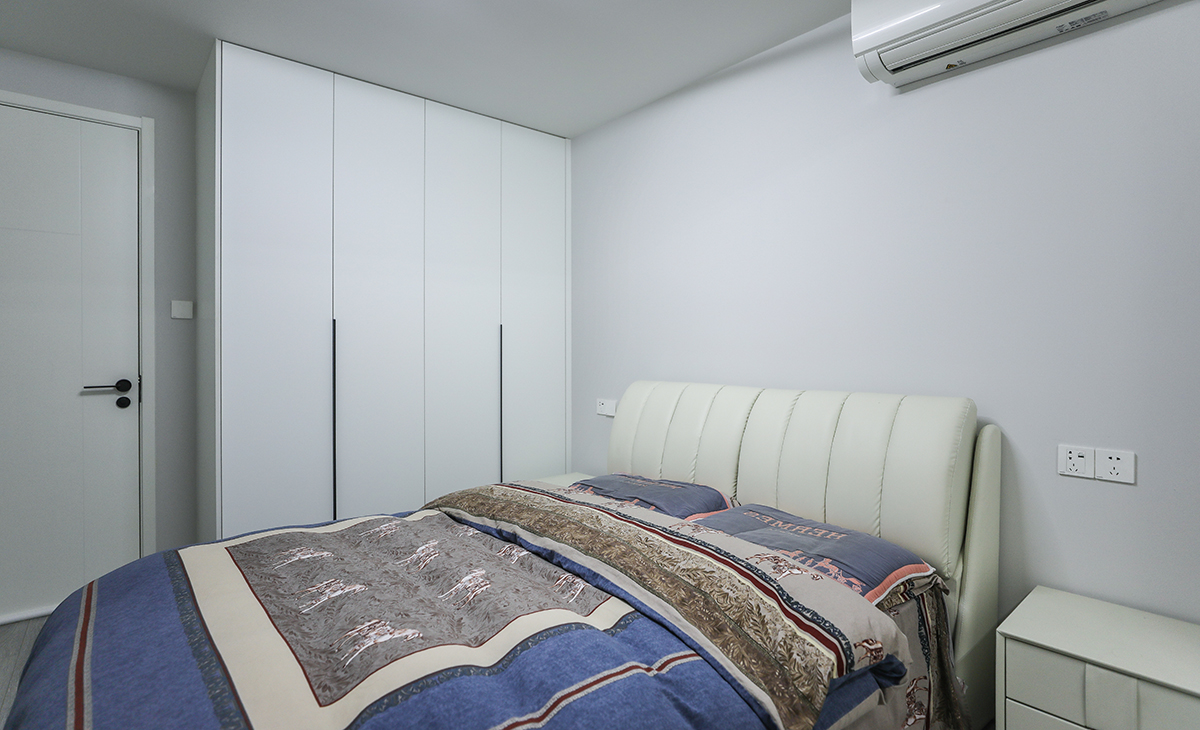 主臥配有淺灰色地板，所以床選擇的是米色牛皮質(zhì)感，衣柜門板也是白色，這樣和地板黑白灰色調(diào)相搭配，一點(diǎn)不突兀，頂面圓型吊扇燈，實(shí)現(xiàn)方中有圓，圓中有方，造型以簡(jiǎn)潔平板為主，方便打理，體現(xiàn)了簡(jiǎn)約風(fēng)格的簡(jiǎn)潔、隨意，不拘一格。