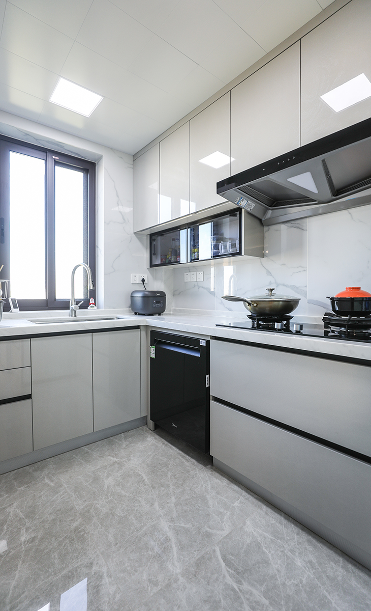 廚房材質明亮方便打理，布局恰當，吊柜下方做一組調料柜，體現主人精致的生活品質，下方13套洗碗機，墻磚白色，地面灰色，淺灰色門板，體現主人高檔次的生活品味。