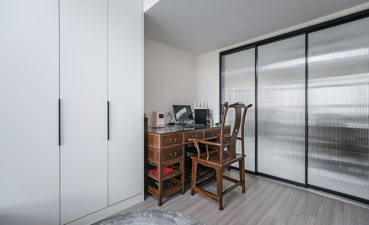 本套房子的小臥室儲物柜設計也是一大亮點，既實用，又有裝飾性，三門儲物柜，門板采用平板一門到頂，配備三聯動的長虹玻璃移門，給人感覺不僅雅致而且有韻味。