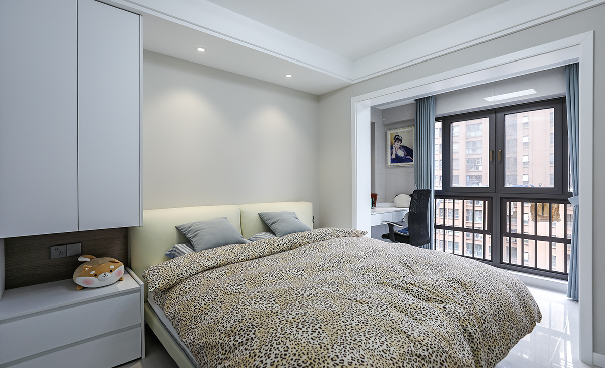 主臥奶咖色墻面，配白色衣柜，搭配灰藍色窗簾造型以簡潔為主，方便打理，體現了簡約風格的簡潔、隨意，不拘一格。