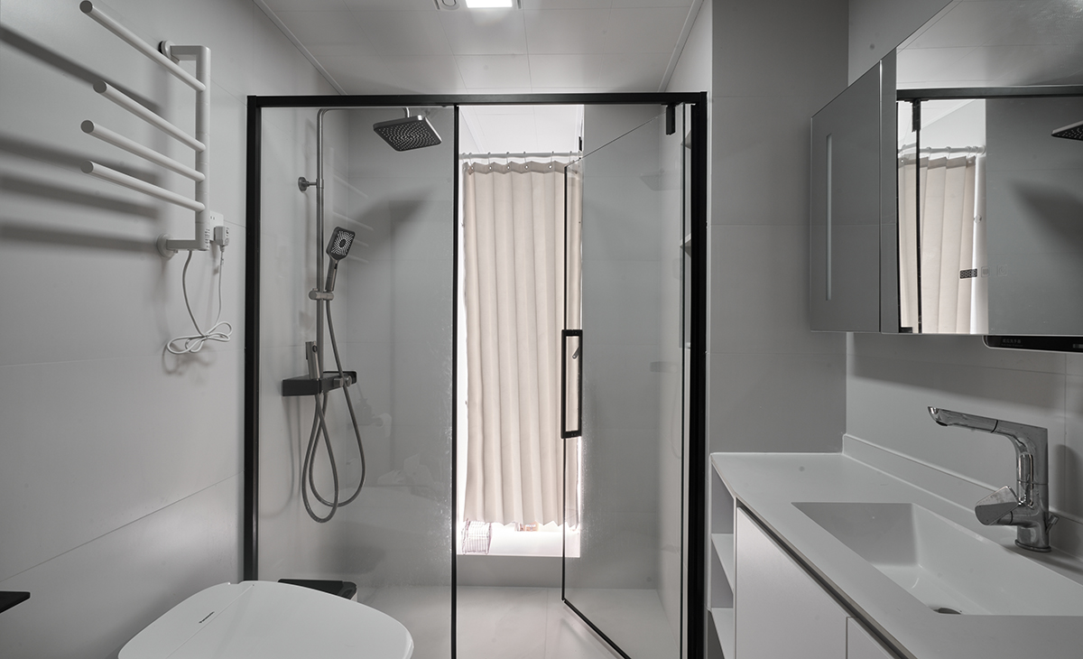 客衛柔光淺灰色墻地磚，黑色邊框淋浴房，白色浴室柜、抽拉龍頭，智能馬桶，體現了客戶的高檔生活品質。