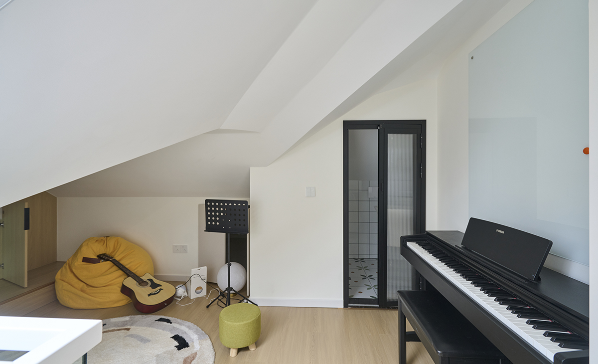 休閑區放一塊地毯，對面放一鋼琴，又隔一個小衛生間，空間充分利用。