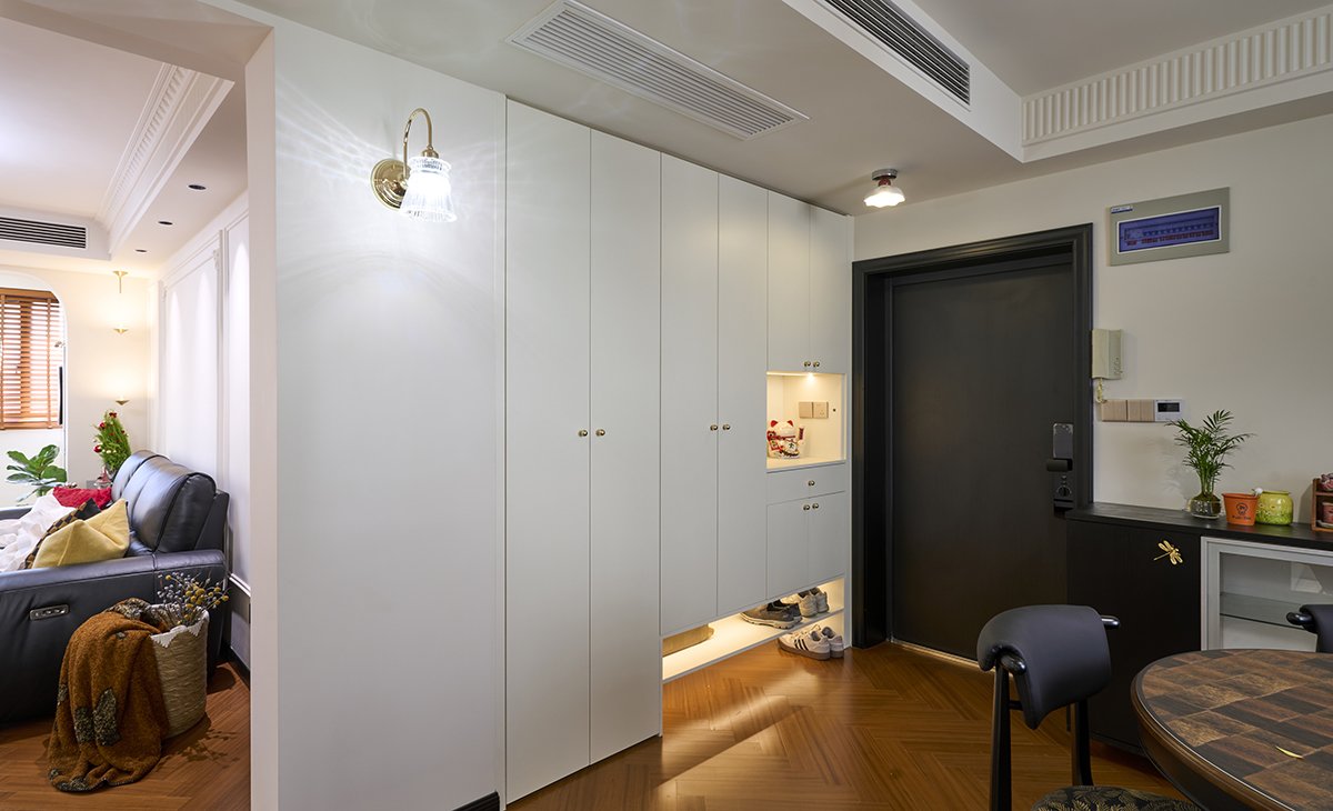 入戶玄關利用原來的薄墻擴大，實現空間利用最大化，一家三口的鞋子妥妥的放