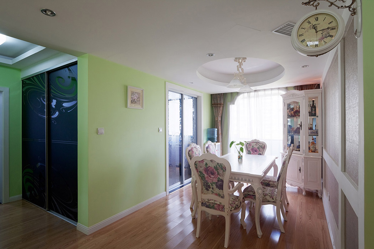 餐廳的拱形門洞與圓形的吊頂相呼應，角落的雕花酒柜和小掛鐘都是吸人眼球的小亮點。
