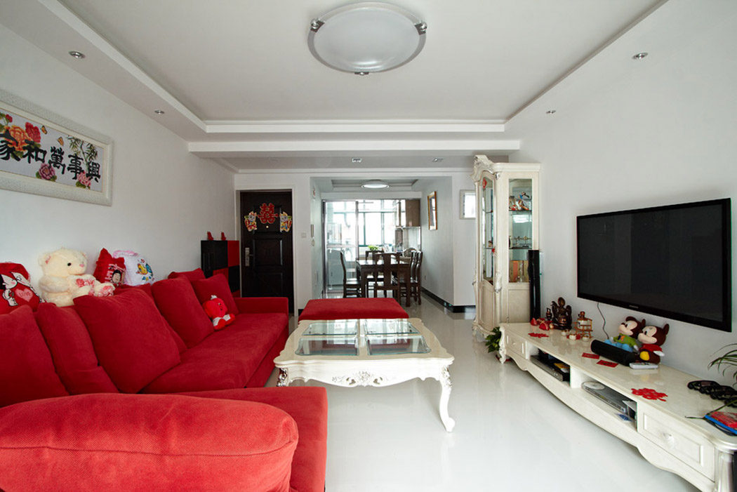 客餐廳采用玻化磚，光線非常明亮，然后再用簡歐的家具來點綴，顯現(xiàn)出一種淺色的奢華，紅色沙發(fā)在淺色中起到畫龍點睛的作用，顯現(xiàn)出婚房的喜慶。
