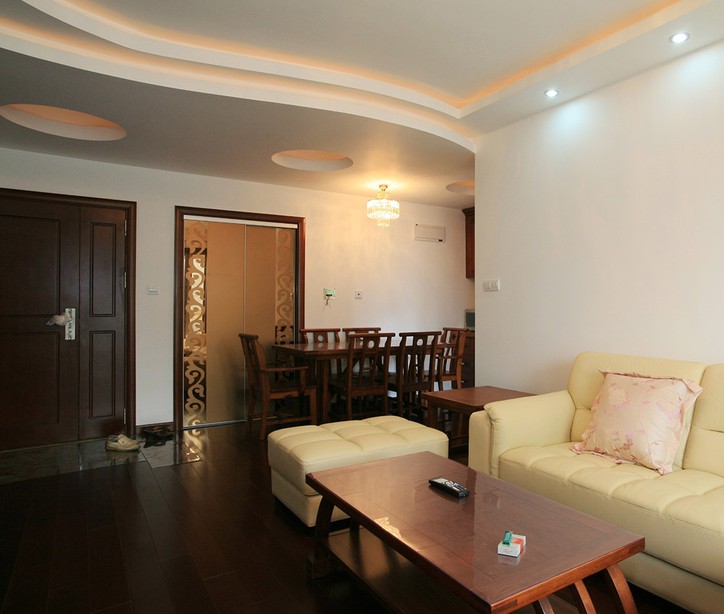 客廳轉入餐廳一兩步，餐廳一套中式的餐桌；頂部做了弧形吊頂，再以大小圓給頂部做些
