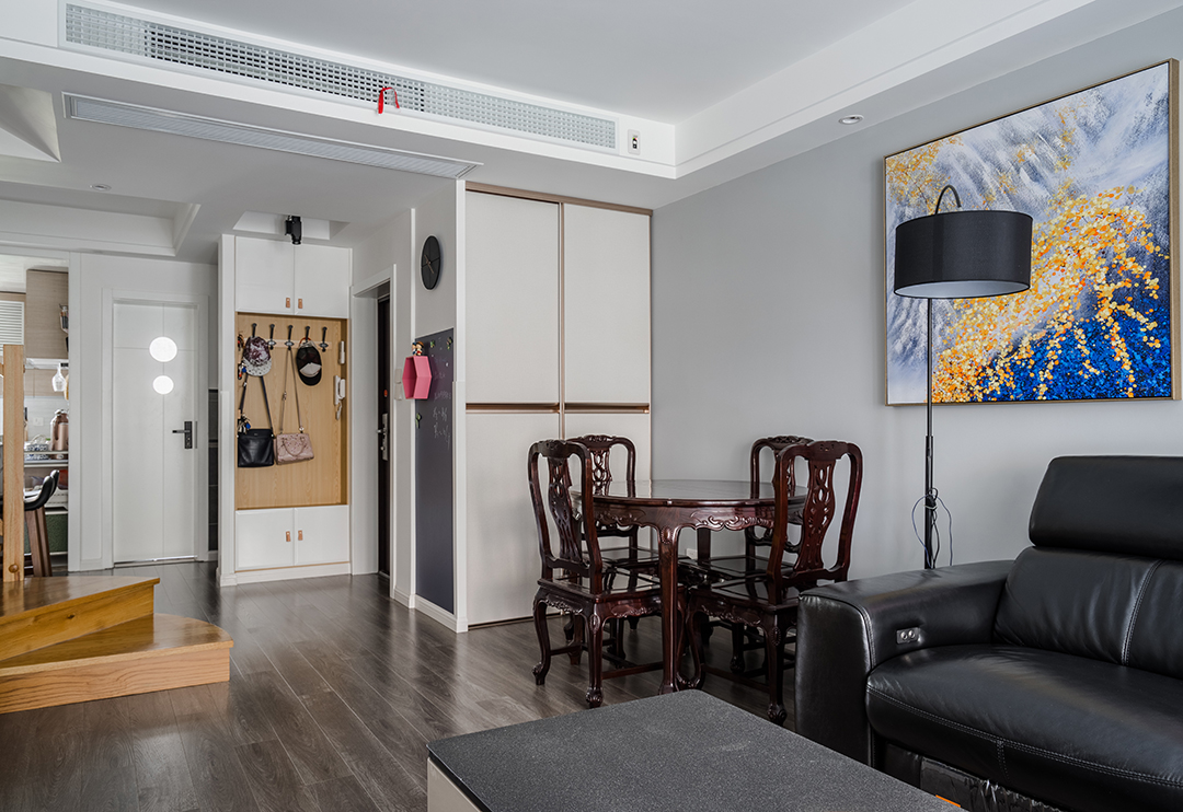 白是淺唱低吟，黑是濃情訴說，原木與石材的完美搭配，剛柔并濟，共同筑一方引人入勝心馳蕩漾的天地。色彩的魔力在于它所傳達的溫暖和釋放的感情是易被察覺與感染的，以黑白灰為主色調的客廳，使整體空間具有一種隱晦的沉穩和出其不意的恬淡美感。
