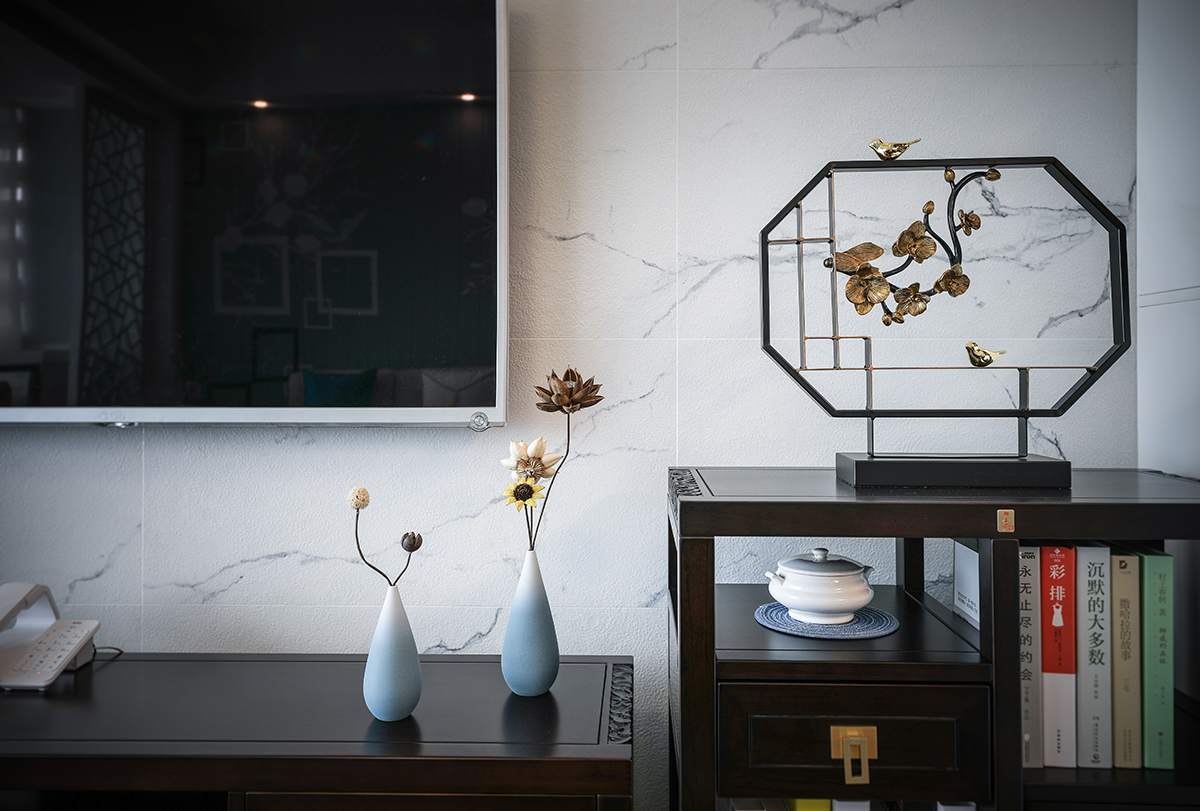 客廳整體風格采用新中式家具，配水墨畫風格的電視背景墻，簡約的沙發背景墻餐廳做了一些中式花格的點綴，使中式與現代的完美結合，在顏色上做了統一，配上精致的木裝飾，玄關柜的鏤空的中式點綴，讓整個空間更加的唯美。
