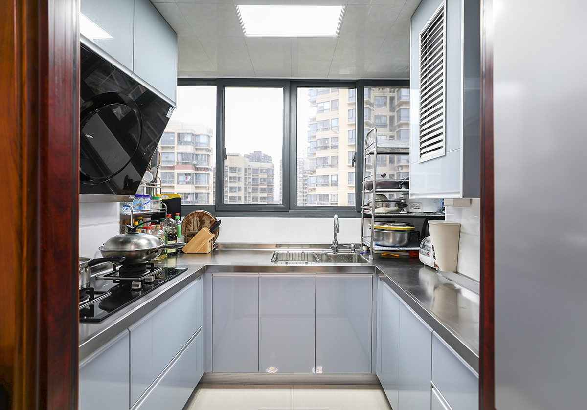 廚房以白色的為底，配以白色櫥柜，更像是隱士般大隱隱于市，深灰的窗戶，黑色煙機灶具更像是水墨畫般的點睛之筆
