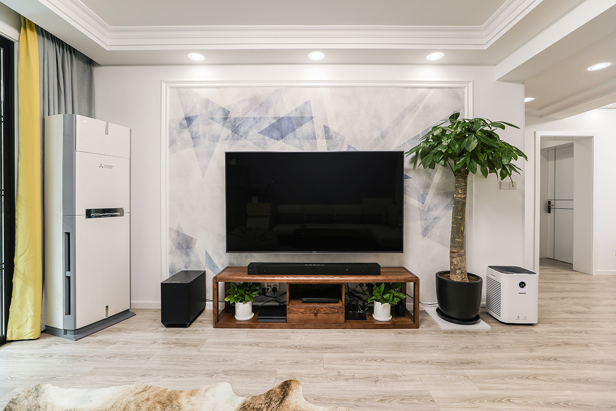 電視背景墻簡潔大氣，色調深淺適中、循序漸進。黃灰相間的窗簾把客廳點綴地淋漓盡致，再加上綠植盆景讓人們的心情放松舒適，使人百看不厭。
