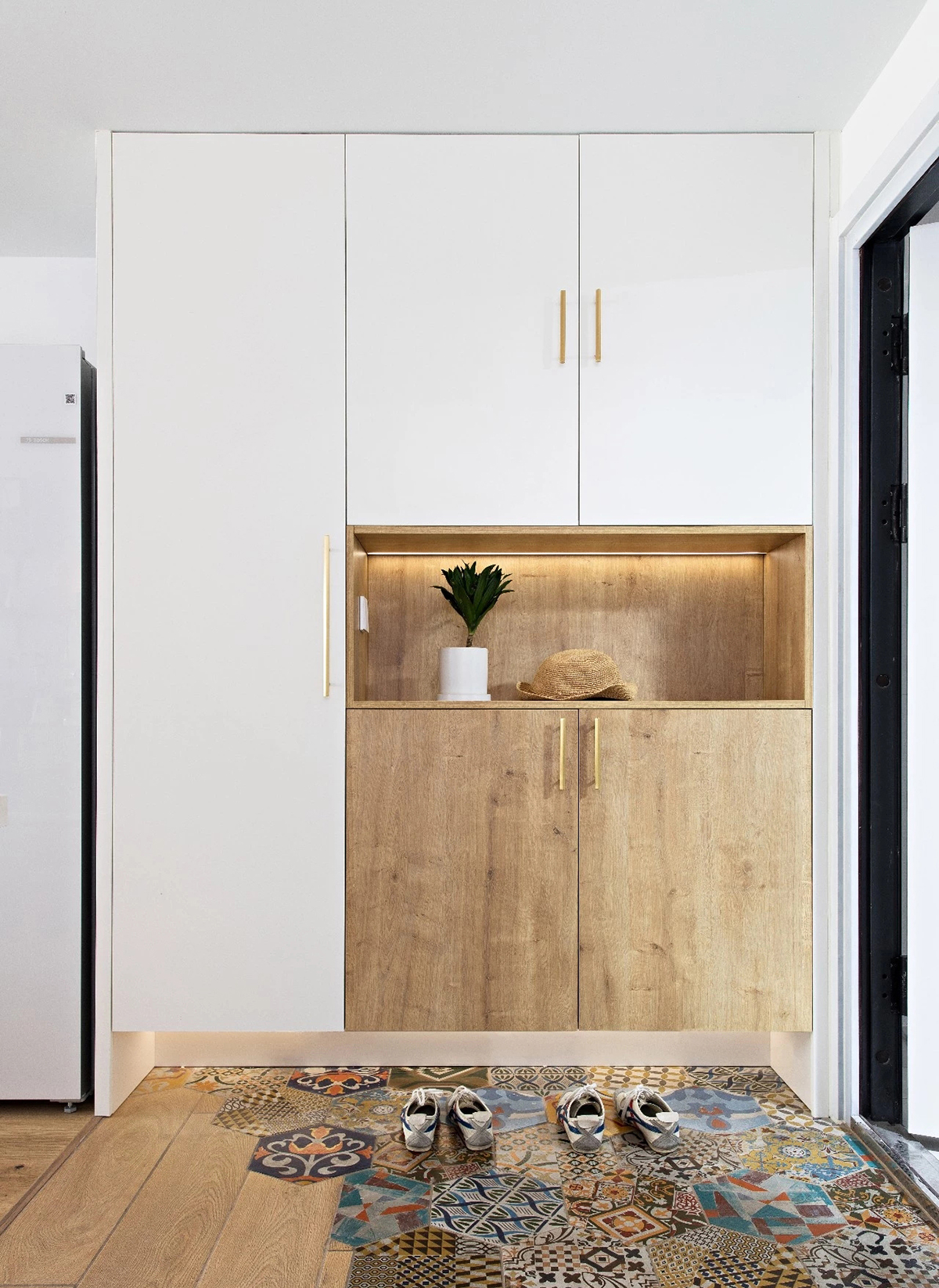 玄關：好心情從入門開始。六角磚拼接地板，柔和過渡到室內，半高鞋柜組合頂柜是藏在門口的收納大胃王。底部留空，常用的鞋子隨便擺也不怕亂糟糟。柜下暗藏燈帶，換鞋不用彎腰就能看得清。
